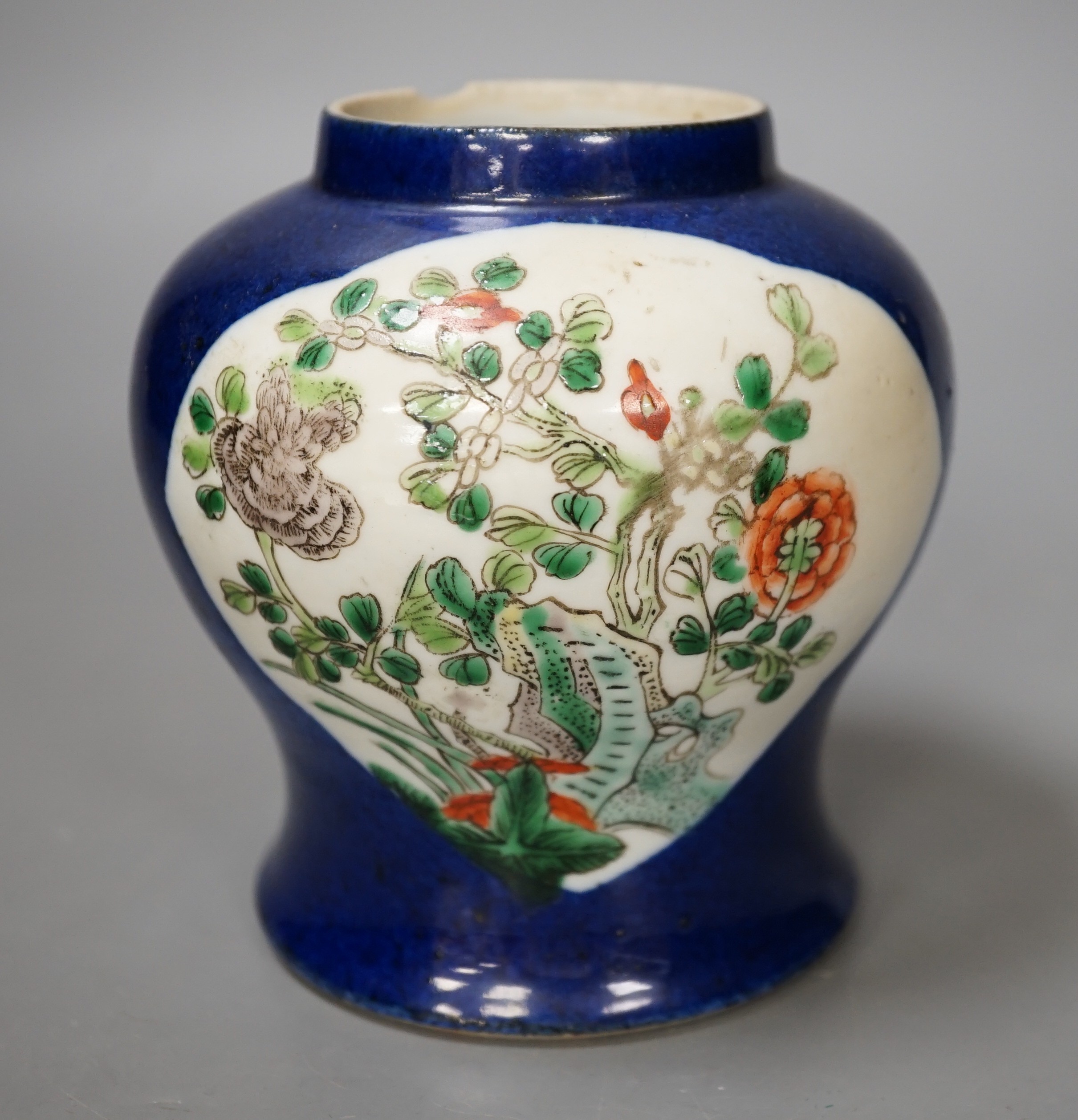 A Chinese powder blue vase, late 19th century, with panelled floral decoration (a.f.). 12cm high